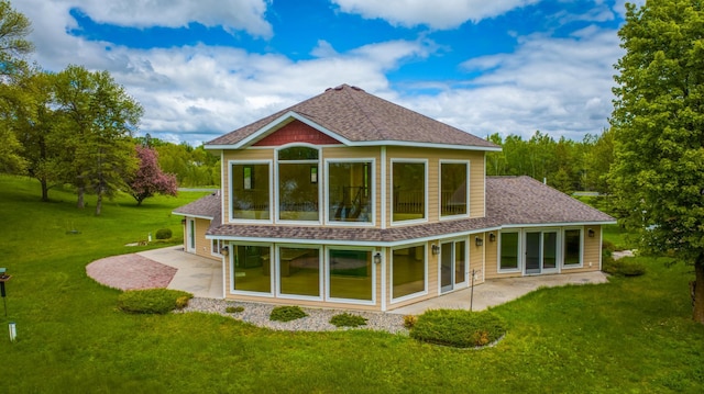 back of property featuring a patio area and a lawn