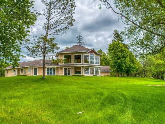 view of front of property with a front lawn and a sunroom