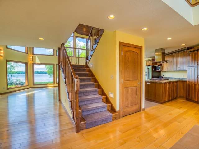 staircase with hardwood / wood-style floors