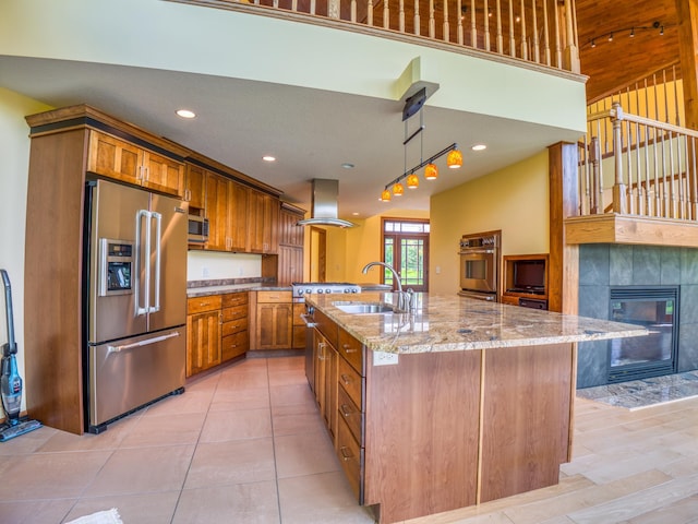 kitchen featuring island range hood, a large island, stainless steel appliances, light stone countertops, and sink