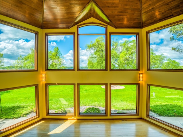 unfurnished sunroom featuring lofted ceiling and wood ceiling