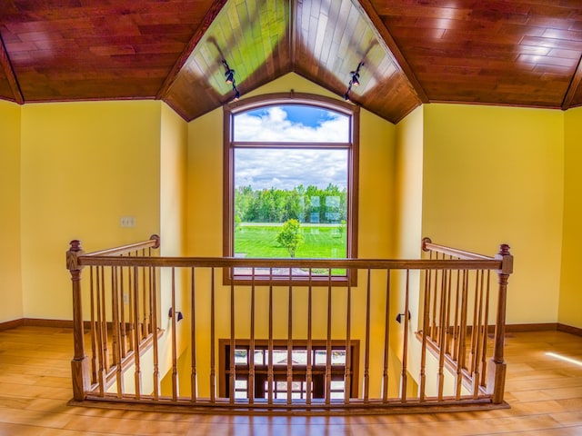 stairway featuring lofted ceiling, wood ceiling, and hardwood / wood-style floors