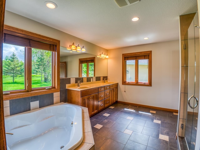 bathroom with vanity, tile patterned flooring, and shower with separate bathtub