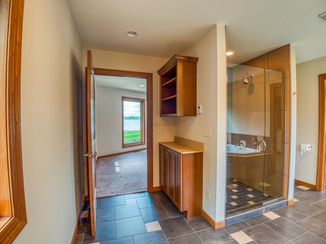 bathroom with a textured ceiling and walk in shower