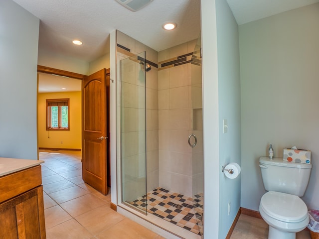 bathroom with toilet, vanity, tile patterned flooring, a shower with shower door, and a textured ceiling