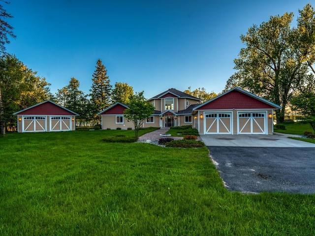 view of front of property featuring a front lawn and a garage