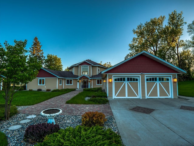 view of front of home with a garage and a front yard