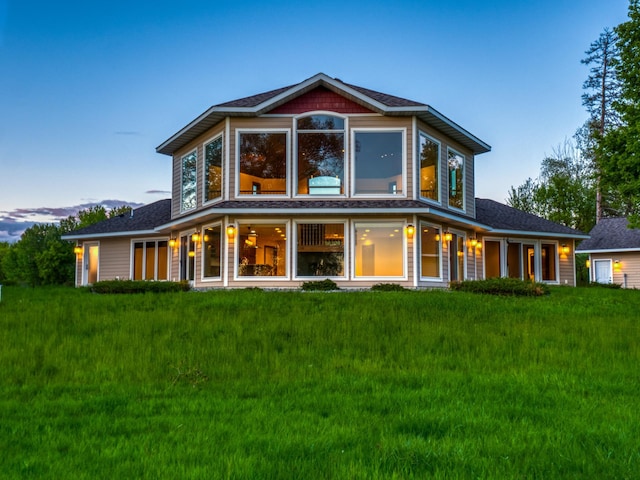 view of back house at dusk