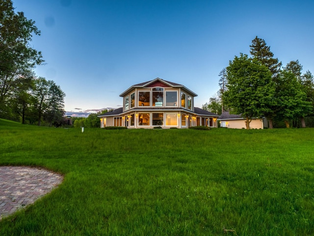 rear view of property with a yard