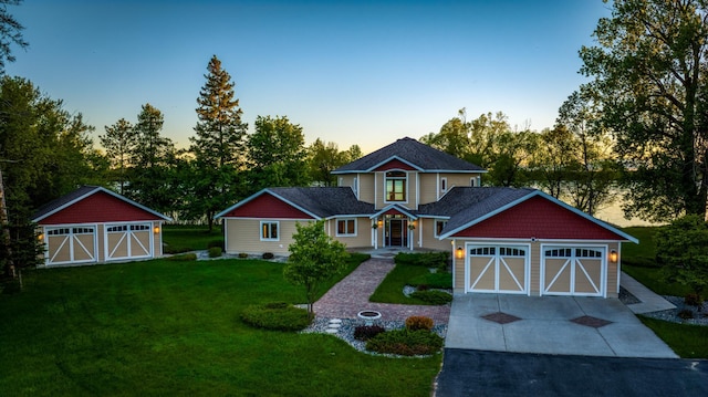 view of front of house featuring a lawn and a garage