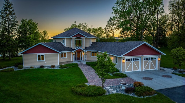 view of front of home with a lawn and a garage