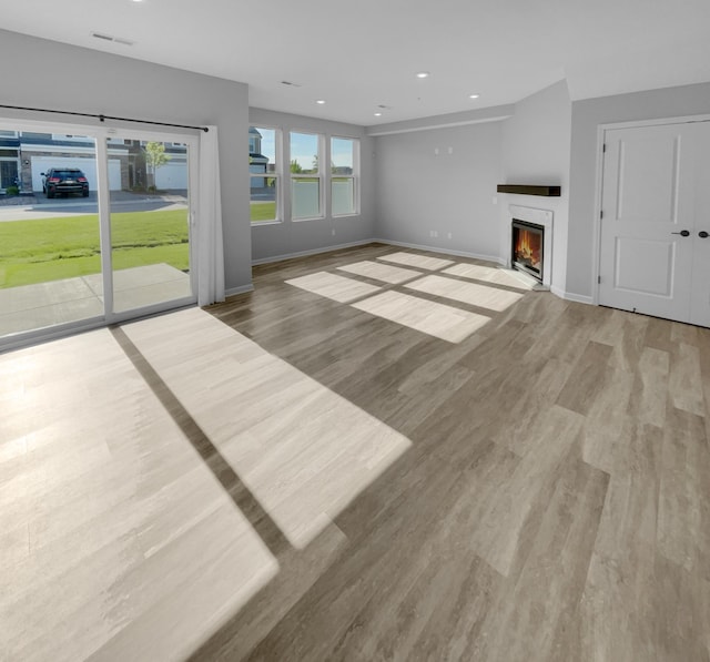 unfurnished living room with light hardwood / wood-style flooring