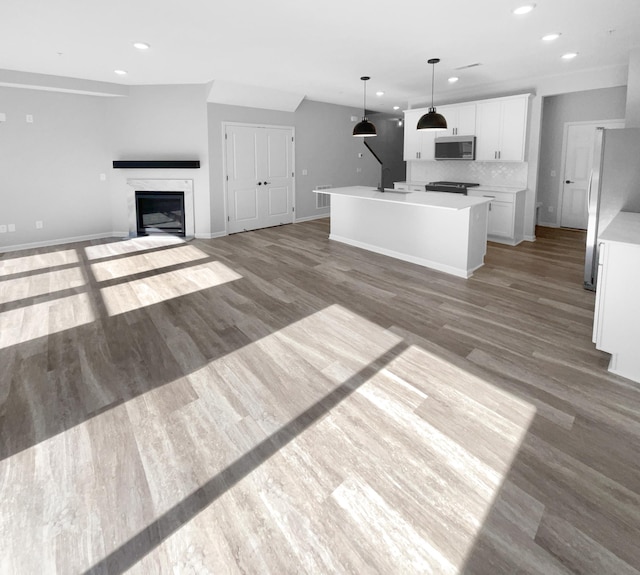 unfurnished living room with wood-type flooring