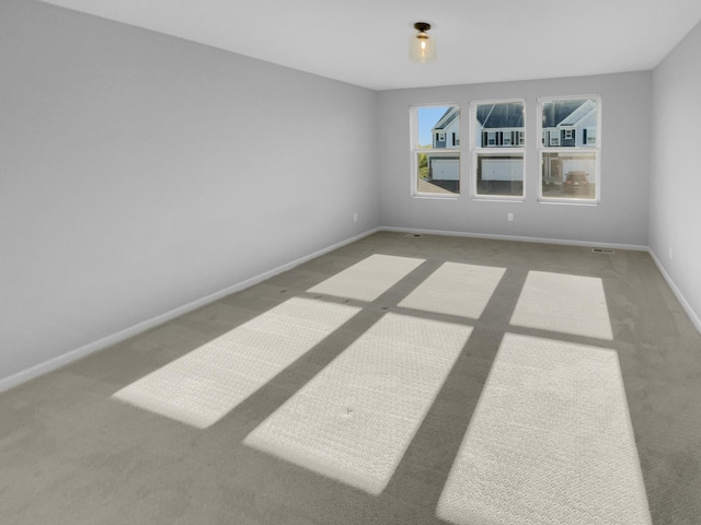 unfurnished room featuring carpet