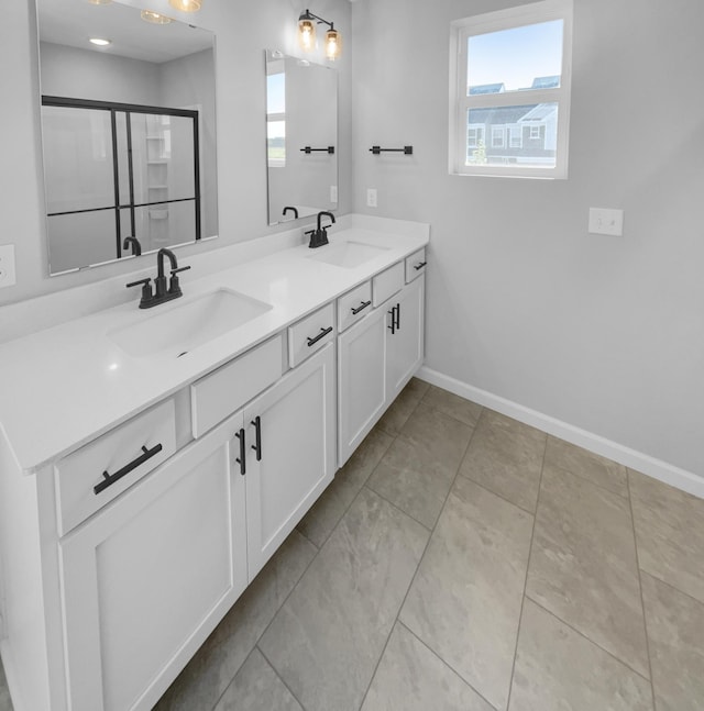 bathroom featuring an enclosed shower, vanity, tile patterned floors, and plenty of natural light