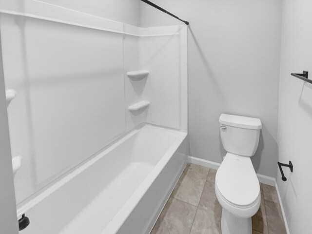 bathroom featuring tile patterned floors, toilet, and shower / bathtub combination