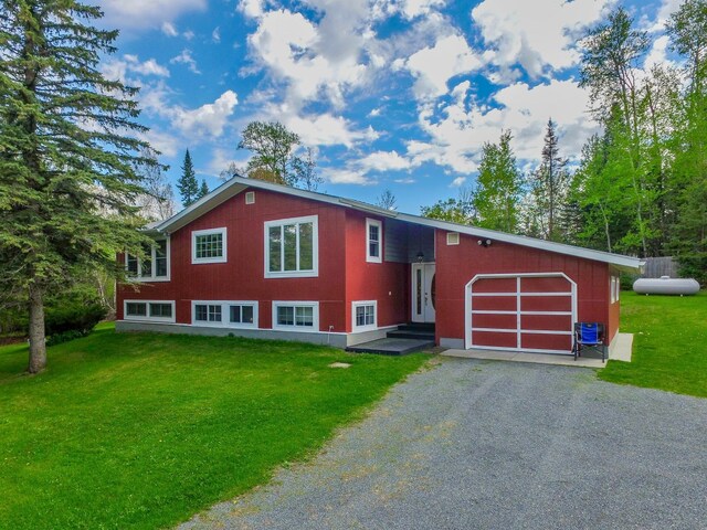 view of front facade with a garage and a front lawn