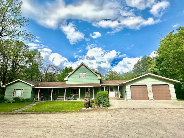 view of front of property with a garage and a front lawn