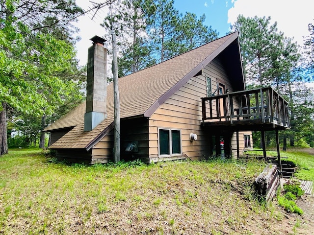 back of house with a yard and a balcony