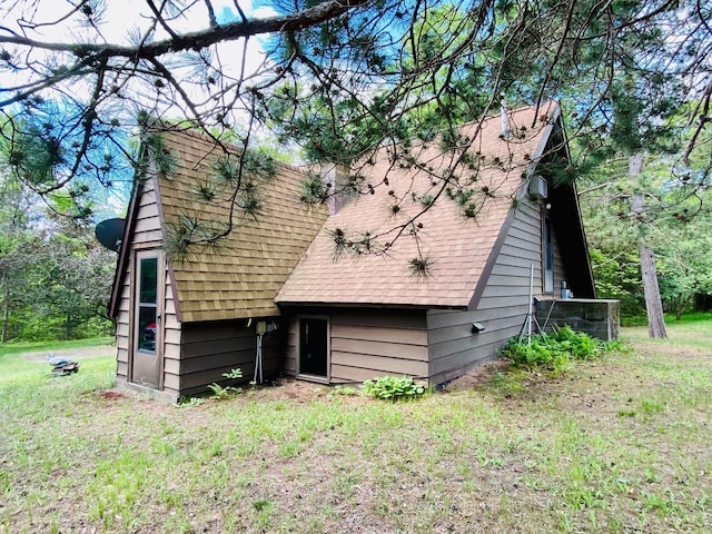 rear view of house featuring a yard