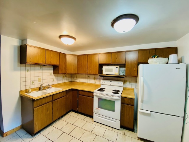 kitchen with white appliances, sink, and tasteful backsplash