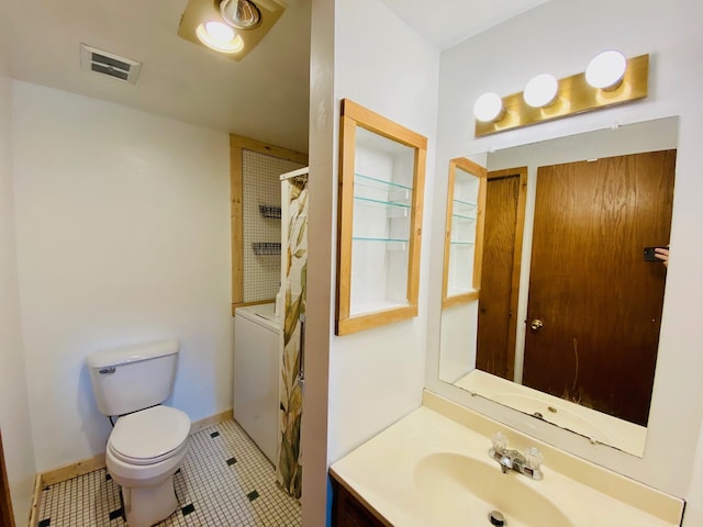 bathroom featuring tile patterned flooring, vanity, and toilet