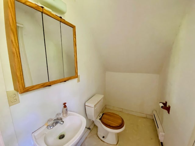 bathroom featuring vaulted ceiling, toilet, sink, and a baseboard radiator