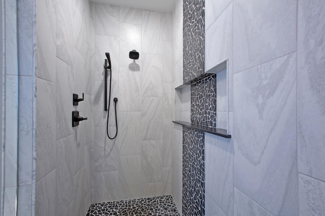 bathroom with a tile shower