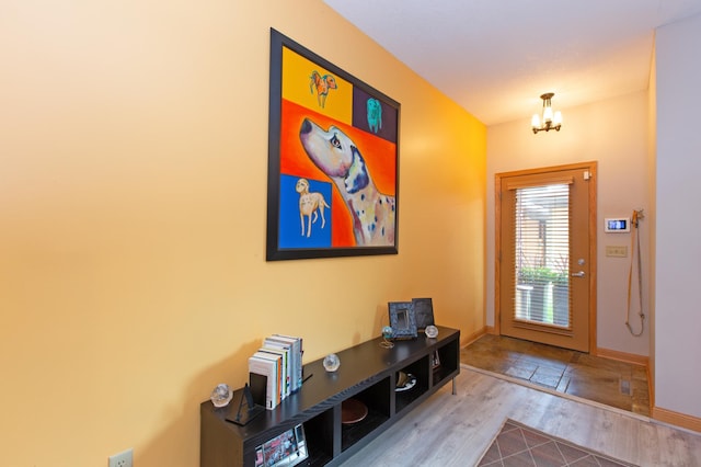 entrance foyer with hardwood / wood-style flooring and a notable chandelier