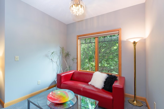 carpeted living room with a chandelier