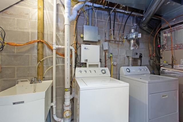 washroom with washing machine and clothes dryer and sink