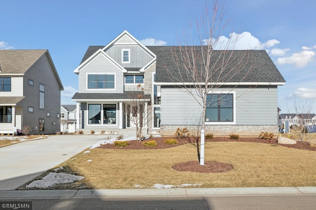 view of front facade with covered porch and a front lawn