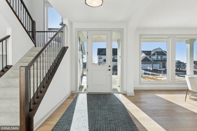 foyer with a healthy amount of sunlight and wood-type flooring