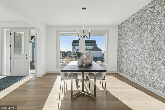 dining area featuring a chandelier and wood-type flooring