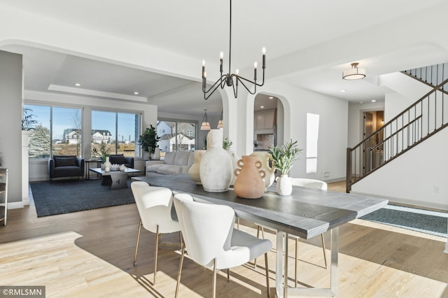 dining room featuring light hardwood / wood-style flooring and a notable chandelier