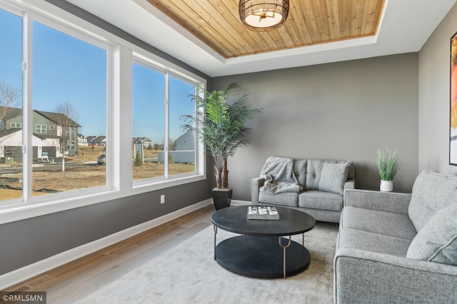 sunroom with a tray ceiling and wood ceiling