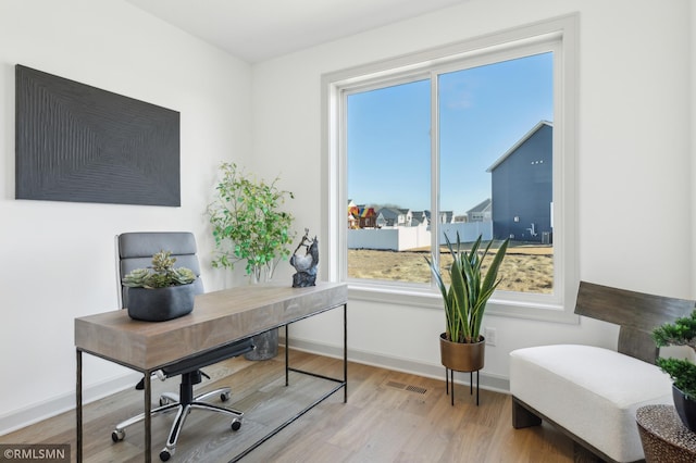 home office with wood-type flooring