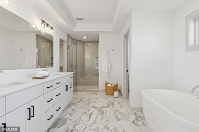 bathroom featuring vanity and independent shower and bath