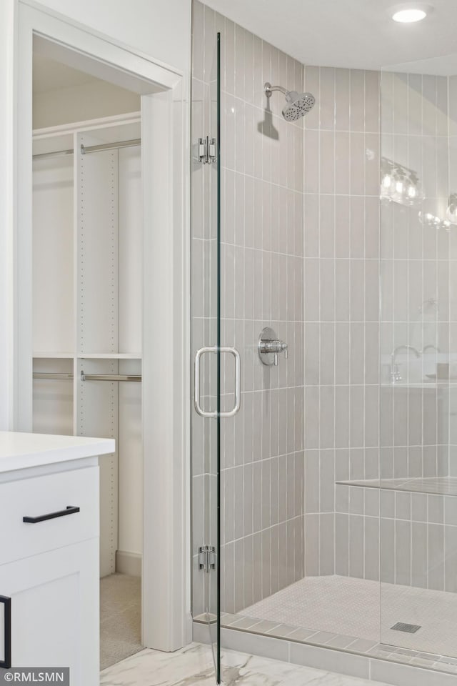 bathroom featuring vanity and an enclosed shower