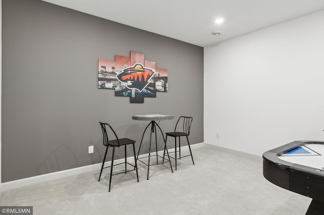 dining area featuring light carpet