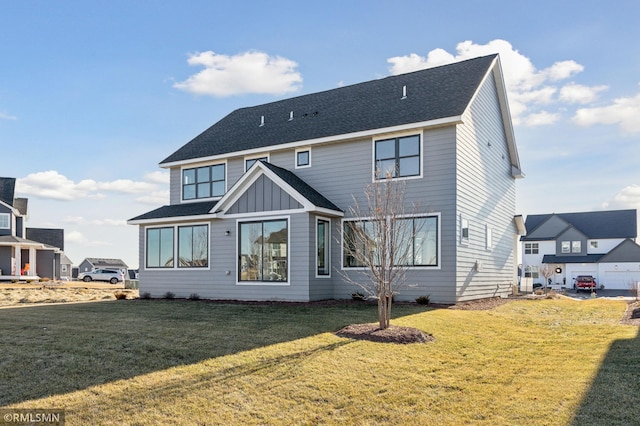 back of house with a lawn