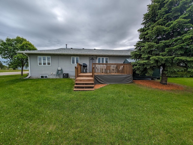 back of property featuring a deck and a yard