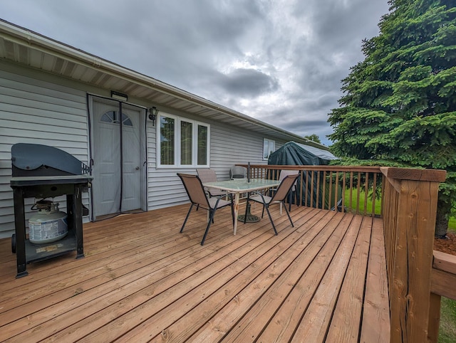 wooden terrace featuring outdoor dining space