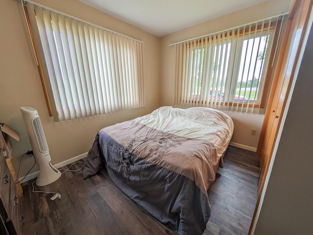 bedroom featuring baseboards and wood finished floors