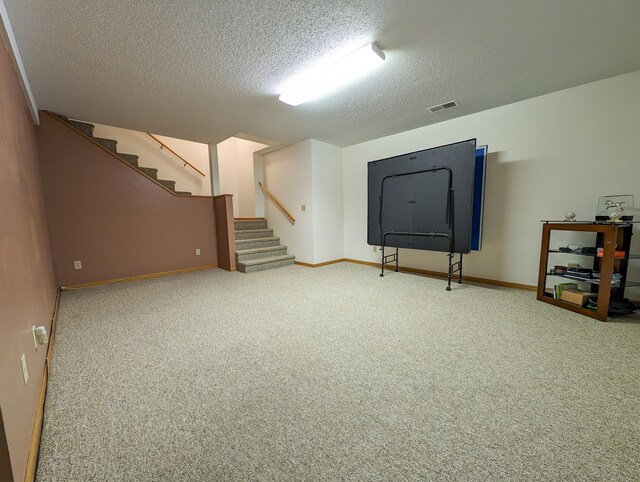 basement featuring carpet and a textured ceiling