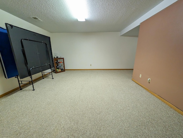 interior space featuring a textured ceiling and carpet flooring