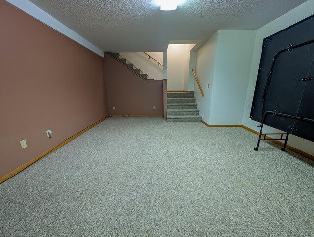 basement with a textured ceiling and carpet floors