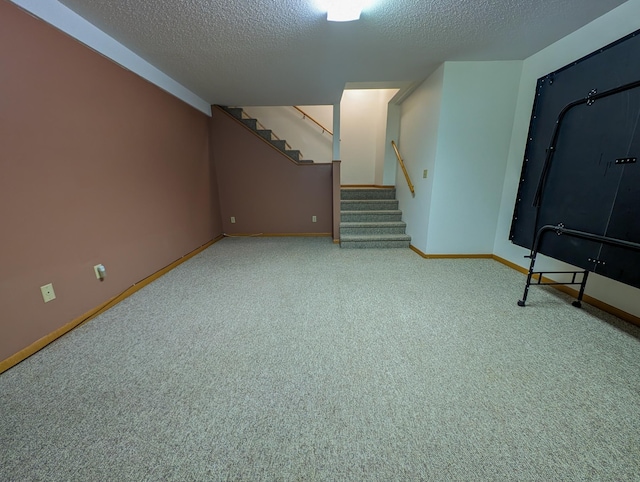 interior space featuring light carpet, a textured ceiling, baseboards, and stairs