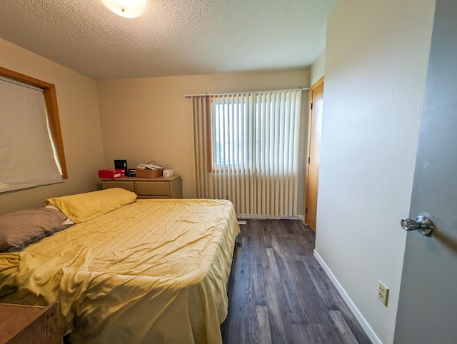 815 6th Ave NE, Perham, MN 56573 - bedroom featuring dark wood finished floors, baseboards, and a textured ceiling