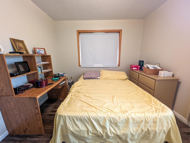 815 6th Ave NE, Perham, MN 56573 - bedroom with dark wood-style floors, baseboards, and a textured ceiling